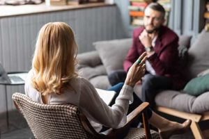 a man and a therapist talk about an individual therapy program for addiction